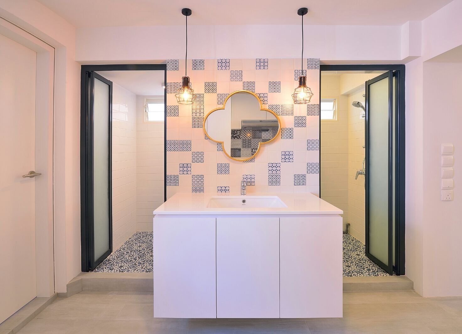 Gold quatrefoil mirror on patterned tile, earlier work by Aura Design & Co.