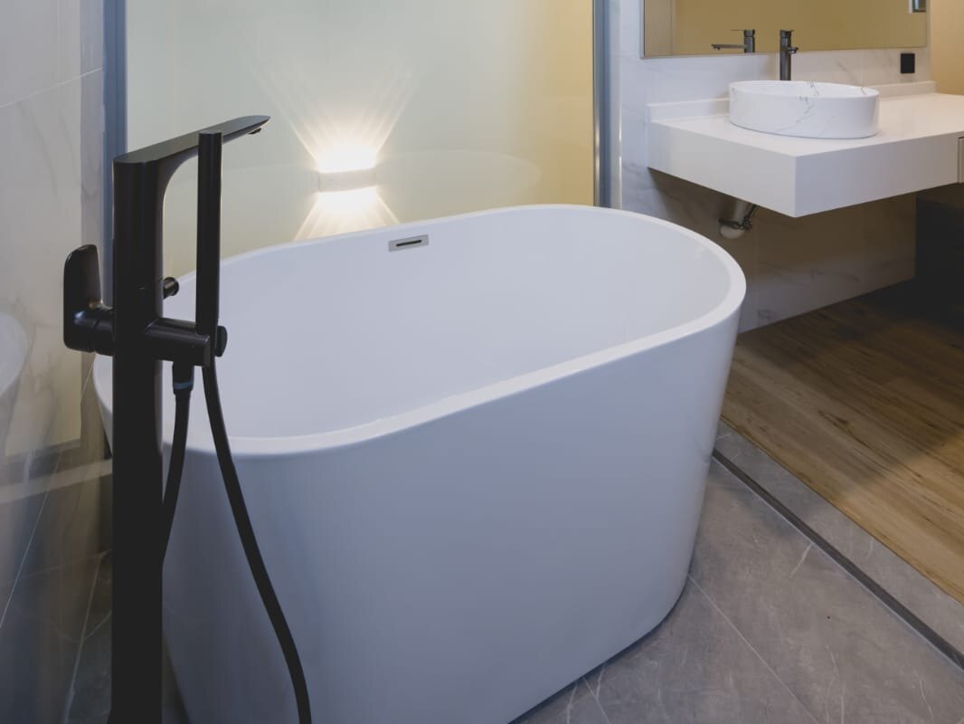 Freestanding tub and black floor-standing tap, earlier work by Aura Design & Co.