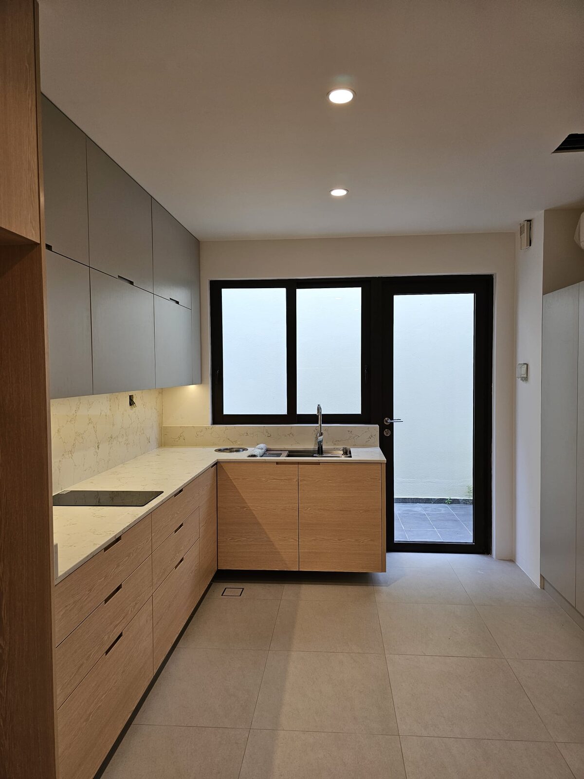 Oak kitchen, marble-look quartz backsplash, earlier work by Aura Design & Co.