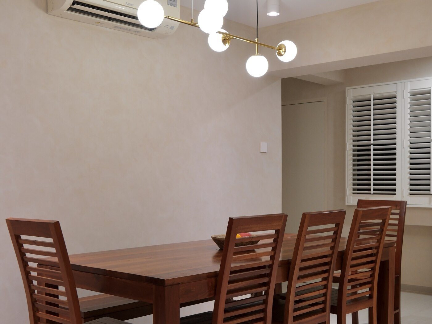 Dining under a brass globe pendant, Santorini Lux, 148 Pasir Ris by Aura Design & Co.